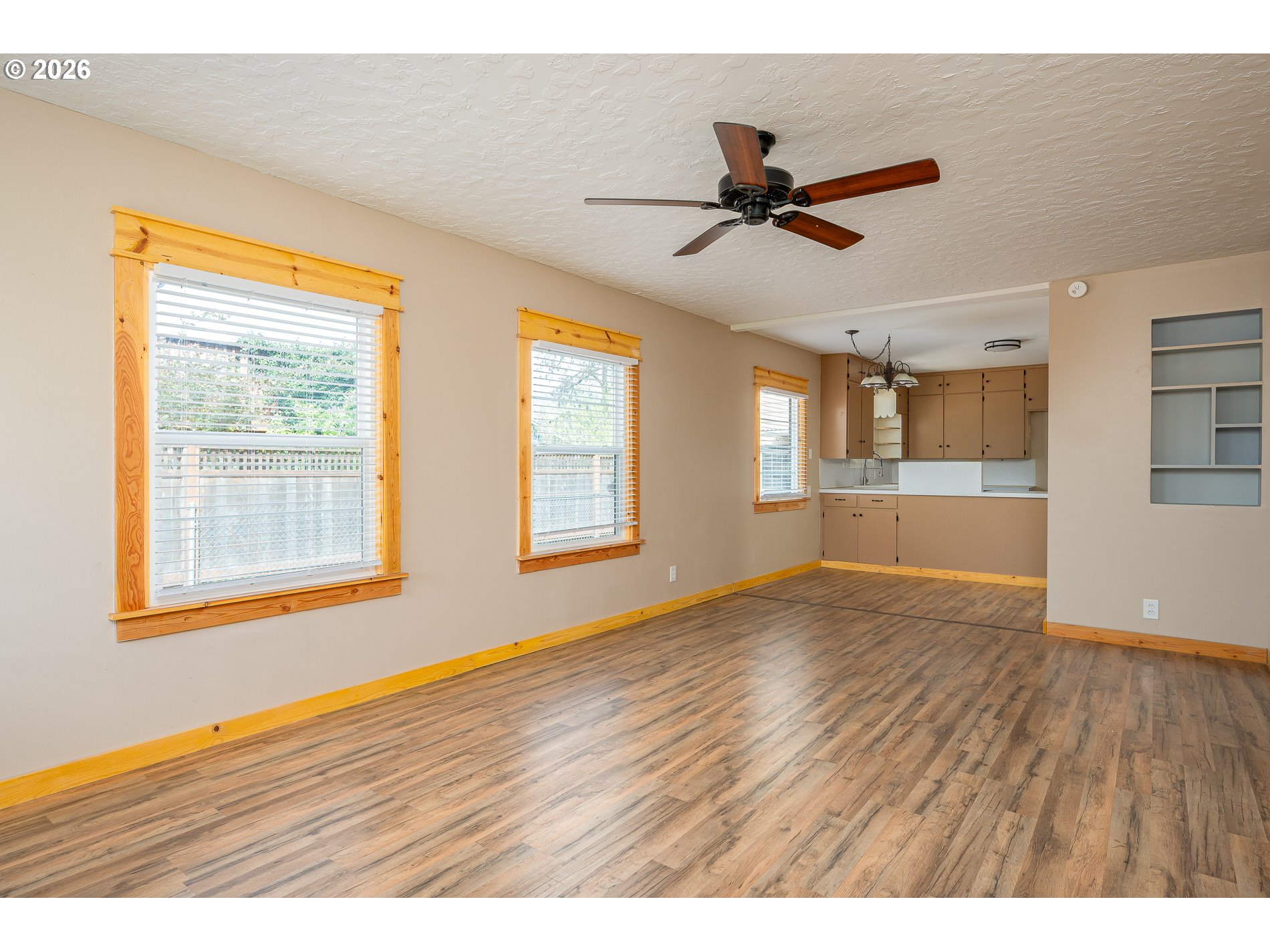 1520 North Maple Street Canby, OR 97013 - Photo 6 of 46 a view of an empty room with wooden floor and a window