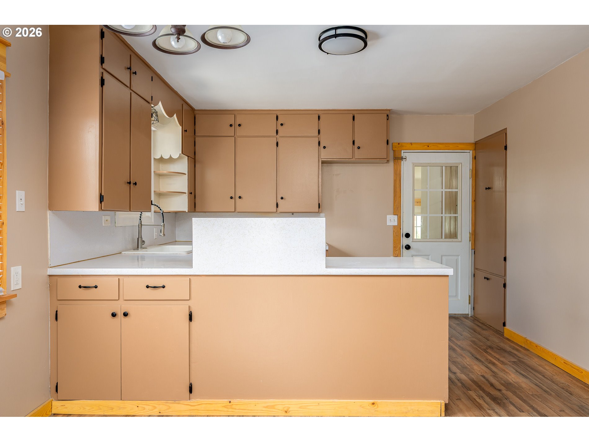 1520 North Maple Street Canby, OR 97013 - Photo 10 of 46 a kitchen with kitchen island cabinets and a refrigerator
