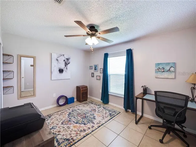 a living room with furniture and a dresser