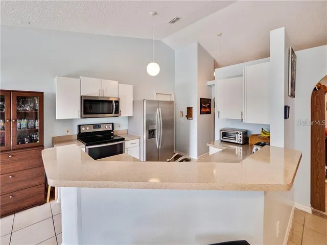 a kitchen with stainless steel appliances a refrigerator sink and microwave