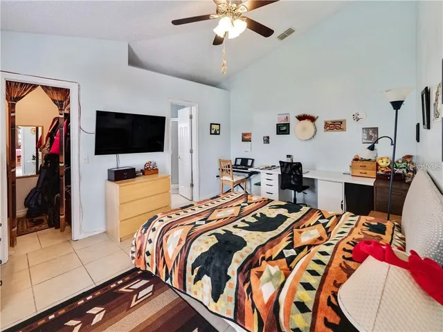 a bed room with a bed and a television