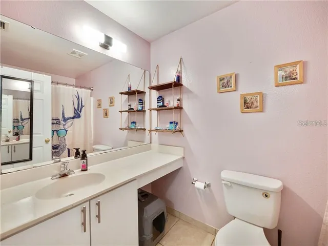 a bathroom with a sink toilet and a mirror