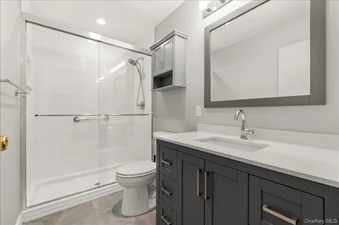 a bathroom with a sink a toilet and a mirror