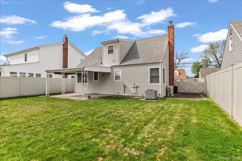 a front view of a house with a yard with plants