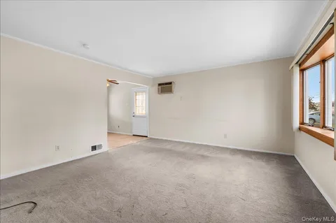 an empty room with windows and closet