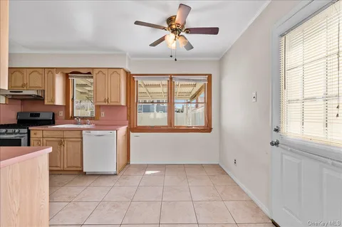 a view of a kitchen with microwave and windows