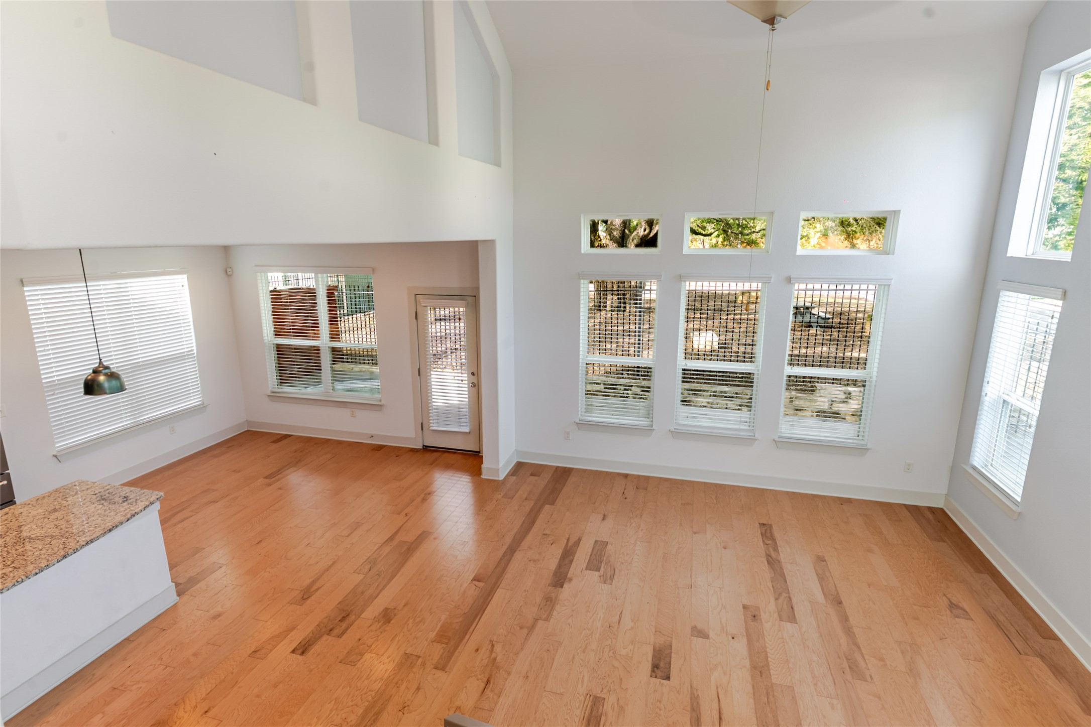 1400 Homespun Road Austin, TX 78745 - Photo 3 of 30 Gleaming hardwood floors and a soaring ceiling define this light-filled main living space.