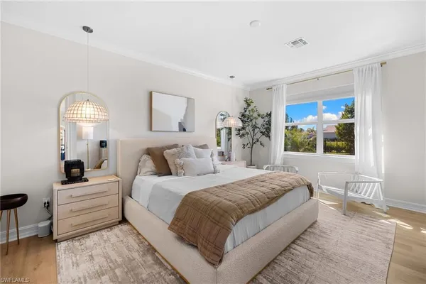 a bedroom with a large bed and a window