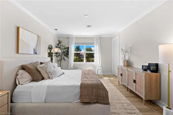 a bedroom with a bed and a large window