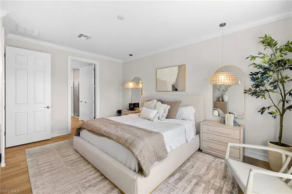 a bedroom with a bed and a chandelier