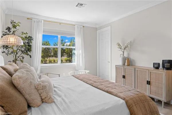 a bedroom with a large bed and a window