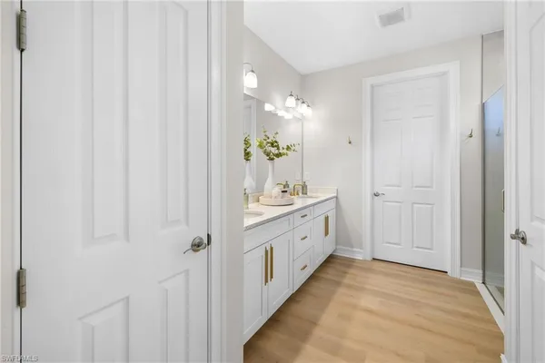 a bathroom with a double vanity sink and mirror