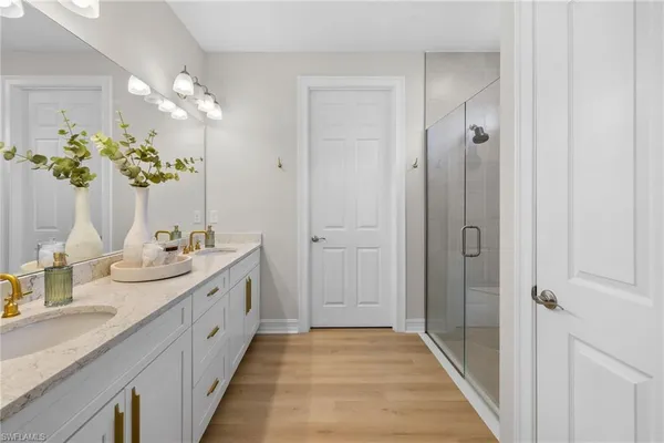 a bathroom with a double vanity sink and a mirror