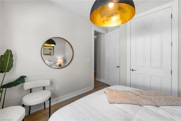 a bedroom with a bed and a mirror