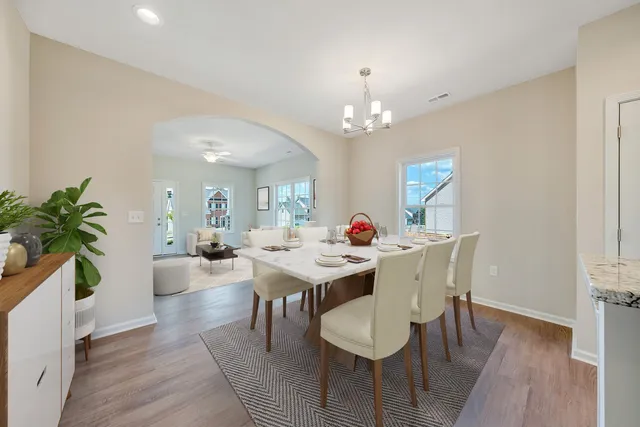 a view of a dining room with furniture window and wooden floor