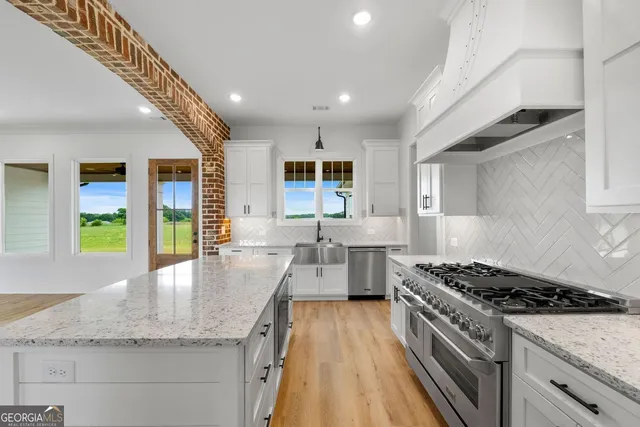 a kitchen with sink stove and refrigerator