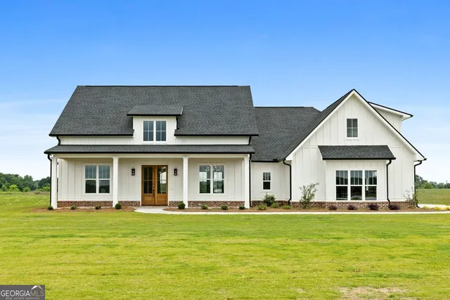 a front view of a house with a garden