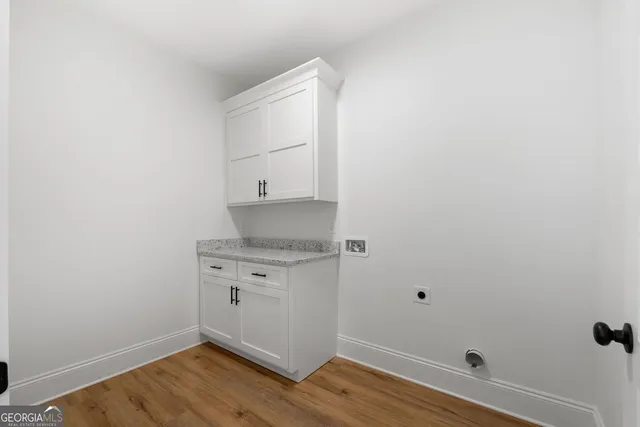 a room with a sink washer and dryer