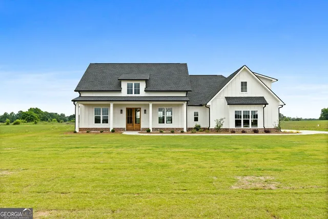 a front view of house with an outdoor space and seating