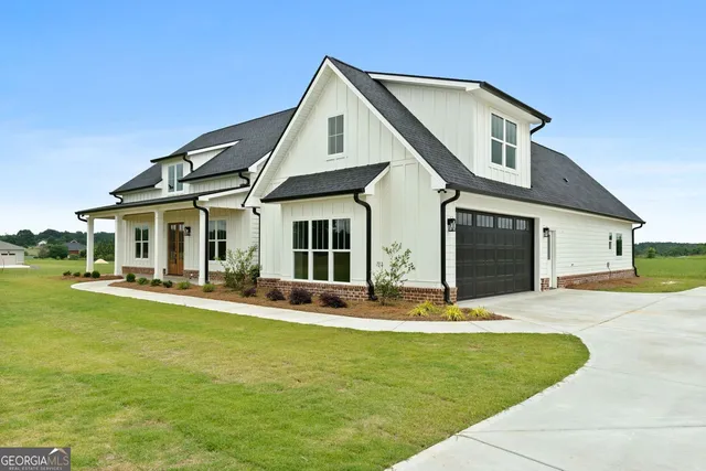 a front view of a house with swimming pool having outdoor seating
