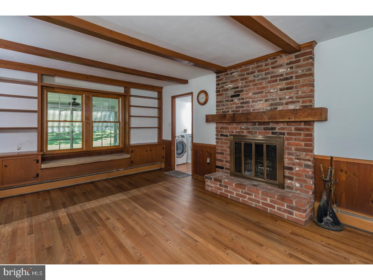 469 Federal City Road Pennington, NJ 08534 - Photo 13 of 25 a living room with a fireplace wooden floor and a large window
