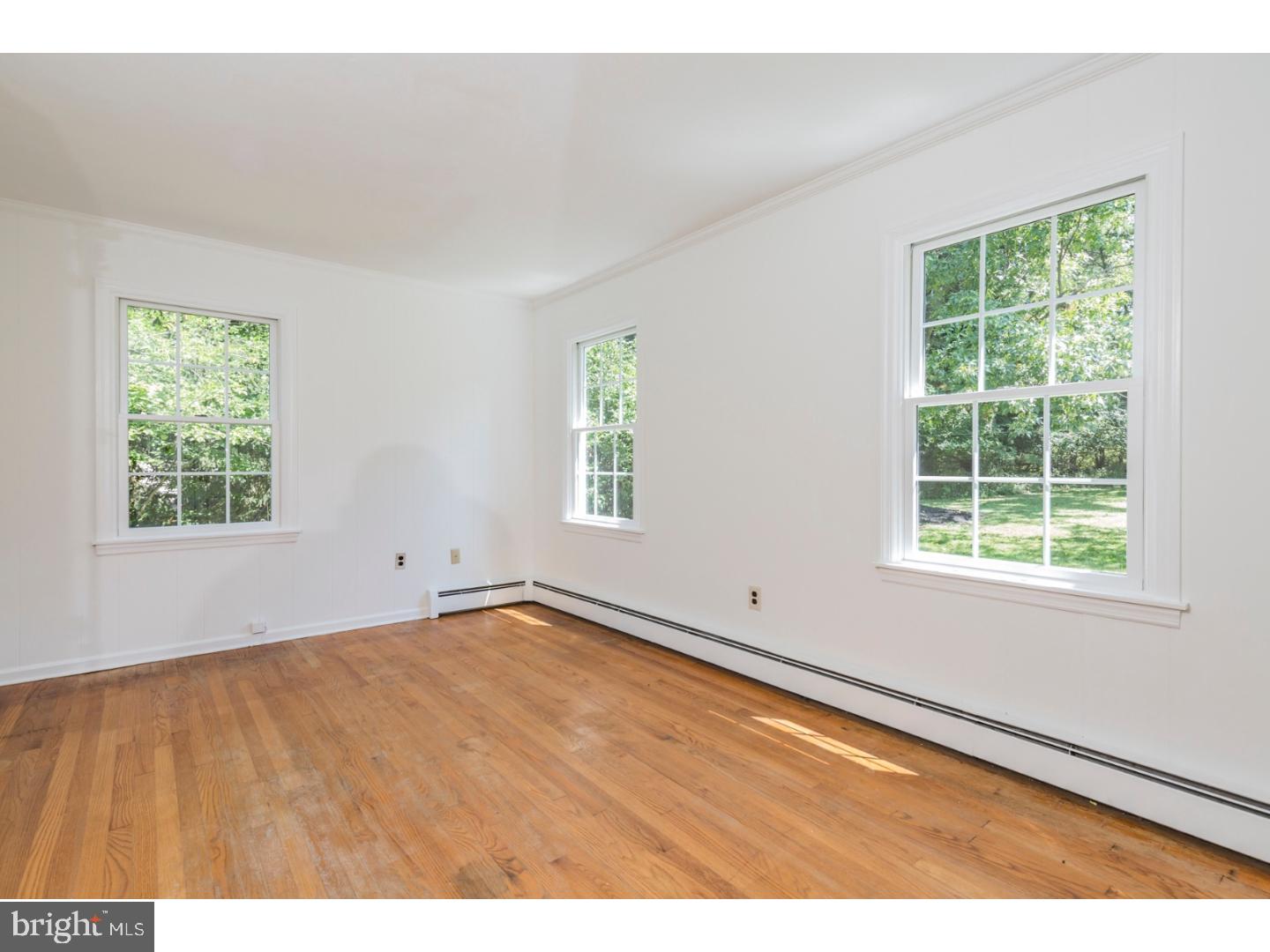 469 Federal City Road Pennington, NJ 08534 - Photo 14 of 25 an empty room with wooden floor and windows