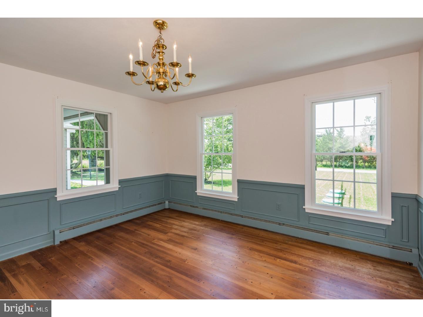 469 Federal City Road Pennington, NJ 08534 - Photo 9 of 25 an empty room with wooden floor chandelier and windows
