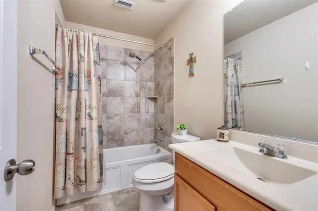 a bathroom with a sink toilet tub and shower