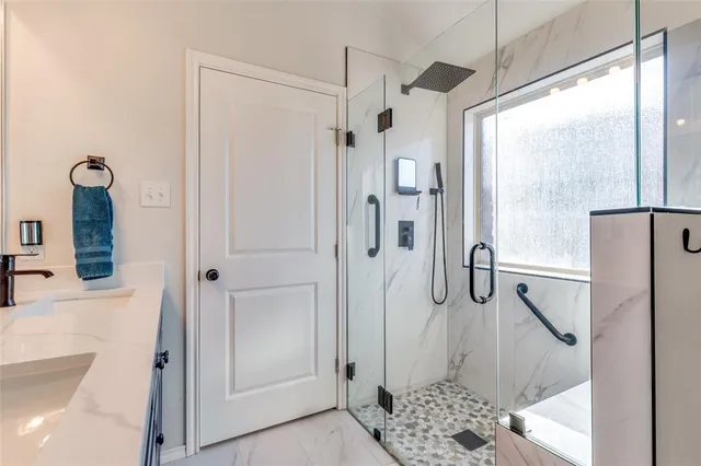 a bathroom with a shower and a sink