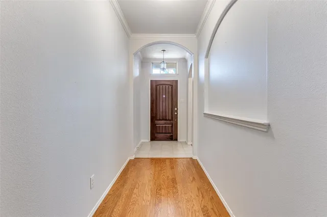 a view of a hallway with wooden floor and a hallway