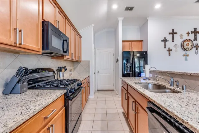 a kitchen with stainless steel appliances granite countertop a sink stove and cabinets