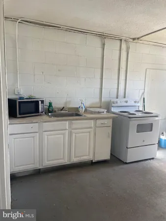 a kitchen with a sink and cabinets