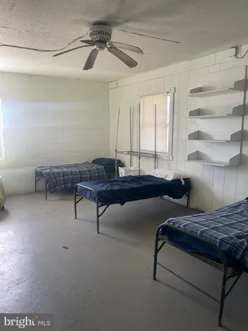 a living room with furniture and a air conditioner vent
