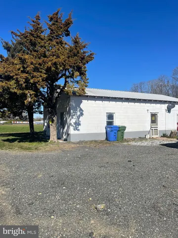 a view of a house with a tree and a yard