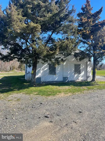 a backyard of a house with a yard and outdoor seating