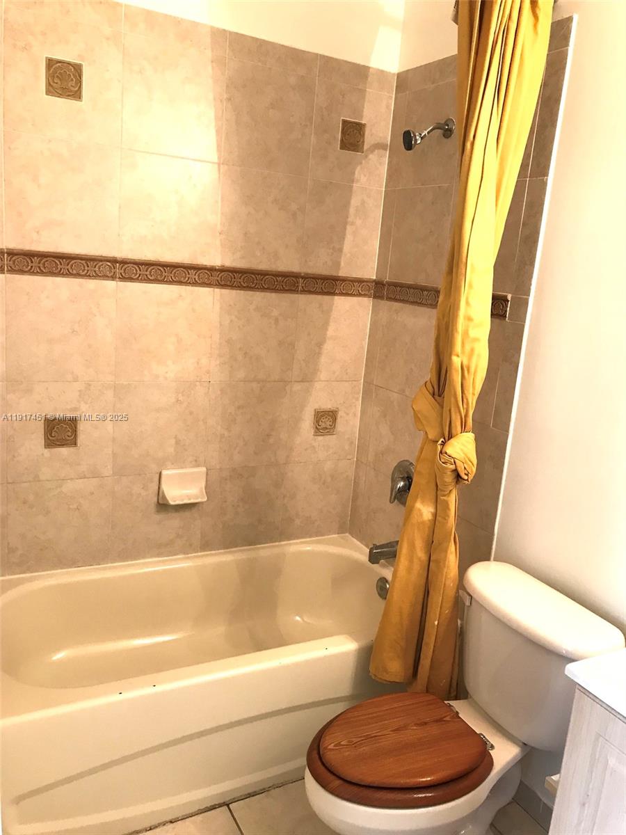 8233 Southwest 25th Court, Unit 104 Miramar, FL 33025 - Photo 11 of 22 a bathroom with a toilet and a bathtub