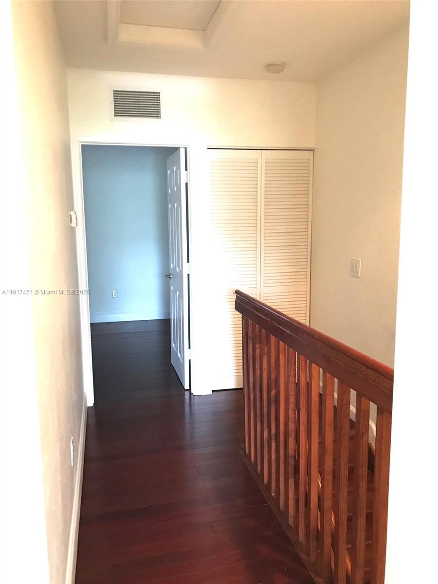 8233 Southwest 25th Court, Unit 104 Miramar, FL 33025 - Photo 13 of 22 a view of a hallway with wooden floor