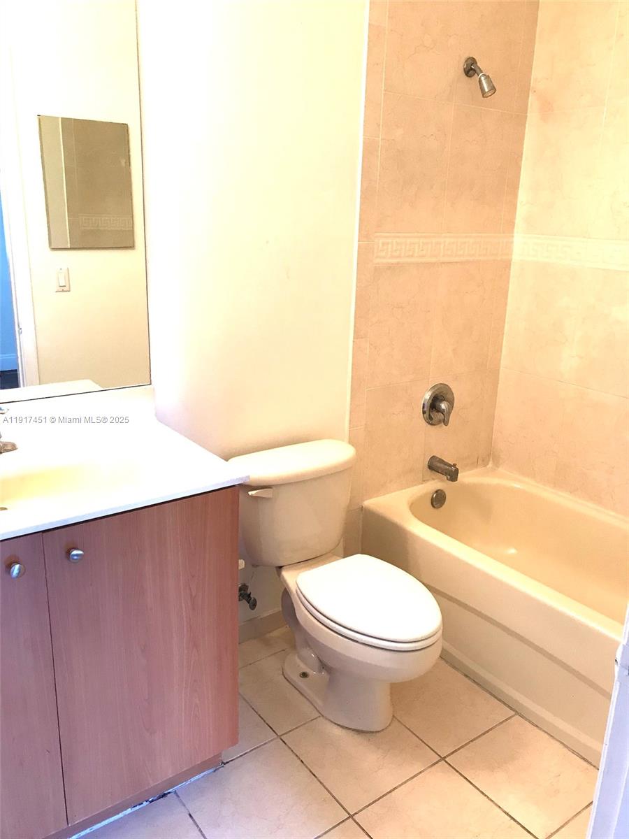 8233 Southwest 25th Court, Unit 104 Miramar, FL 33025 - Photo 16 of 22 a bathroom with a toilet a sink and bathtub