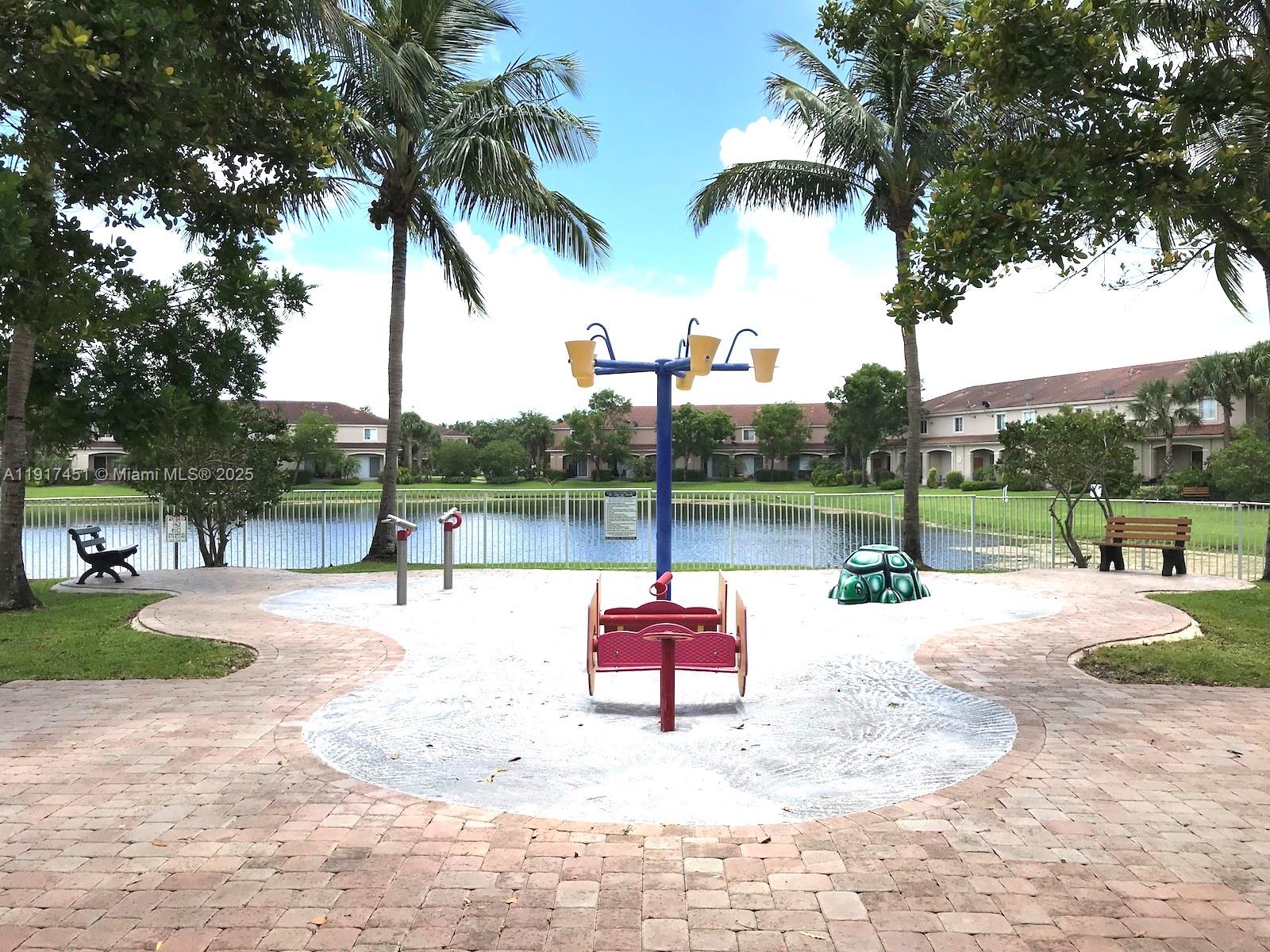 8233 Southwest 25th Court, Unit 104 Miramar, FL 33025 - Photo 19 of 22 a swimming pool with a yard