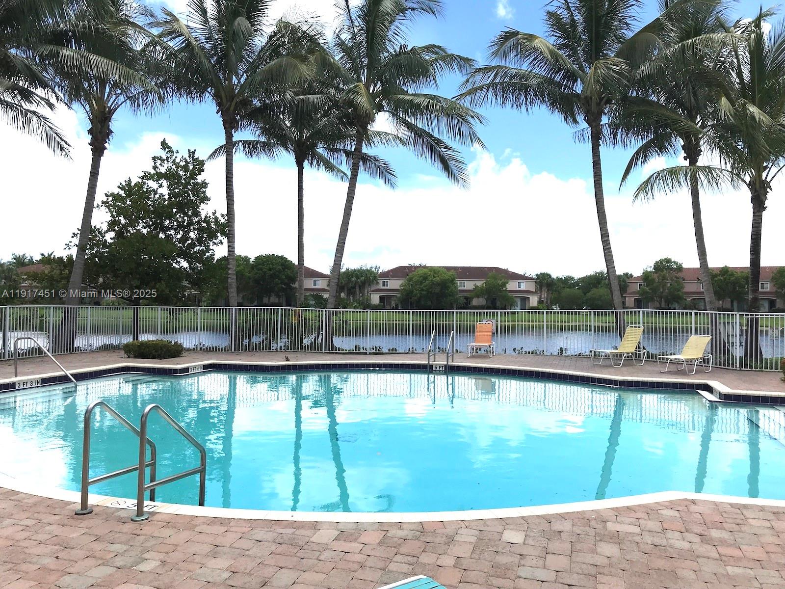 8233 Southwest 25th Court, Unit 104 Miramar, FL 33025 - Photo 21 of 22 a picture of palm trees in front of a lake view