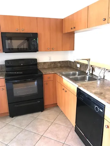 a kitchen with stainless steel appliances wooden cabinets and stove