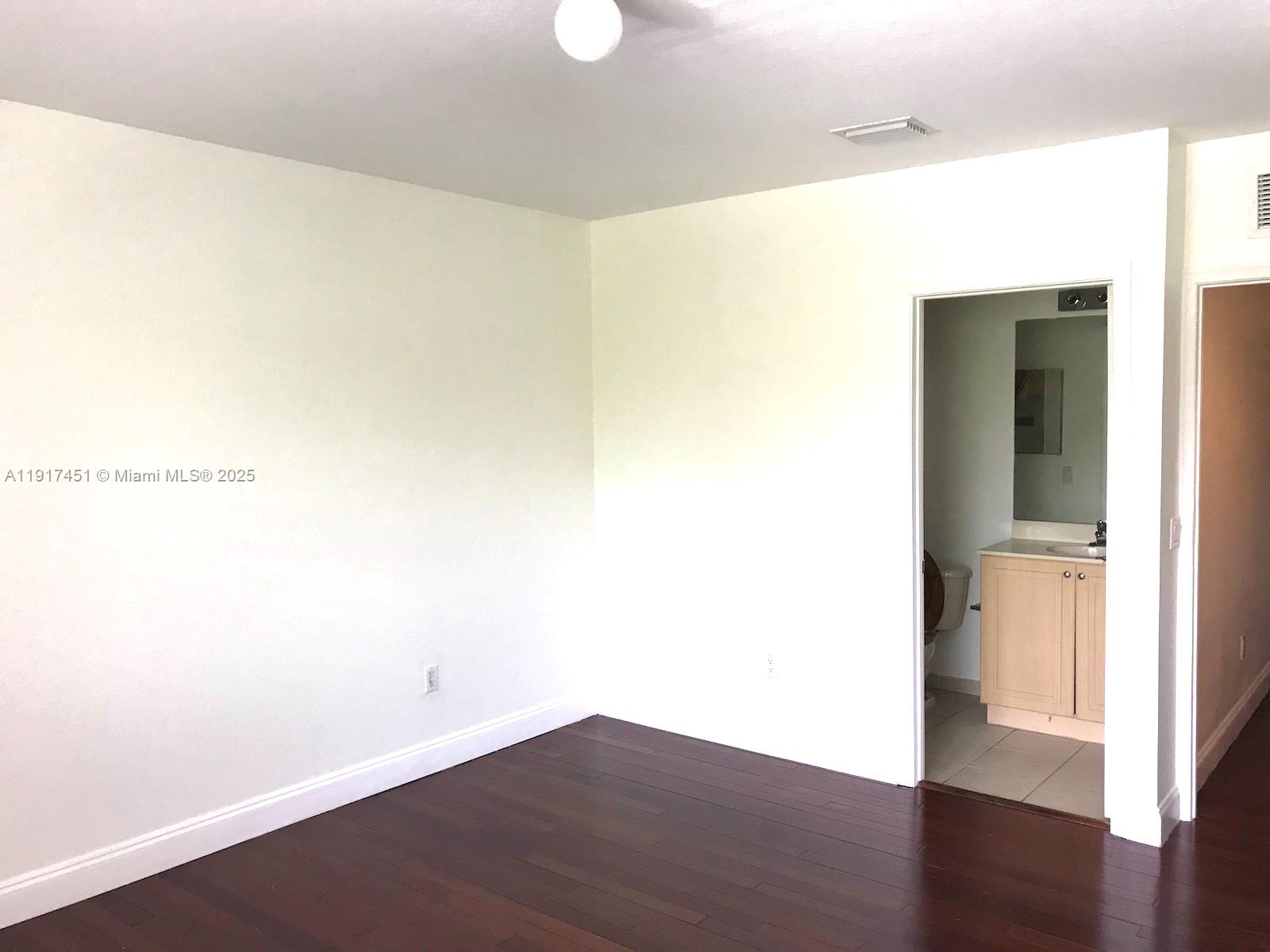 8233 Southwest 25th Court, Unit 104 Miramar, FL 33025 - Photo 10 of 22 a view of a room with wooden floor