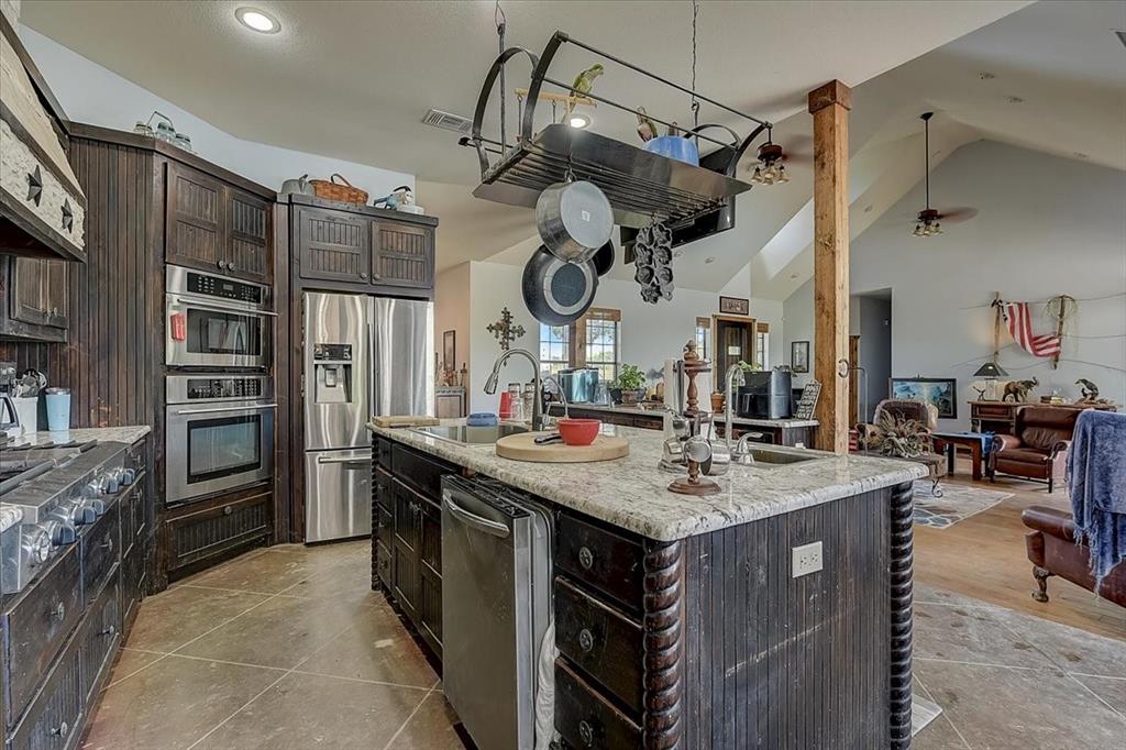 9494 Waide Road Sanger, TX 76266 - Photo 14 of 40 a kitchen with stainless steel appliances granite countertop a sink and cabinets