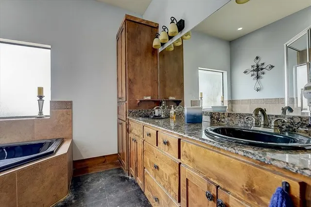 a bathroom with sink a mirror and vanity
