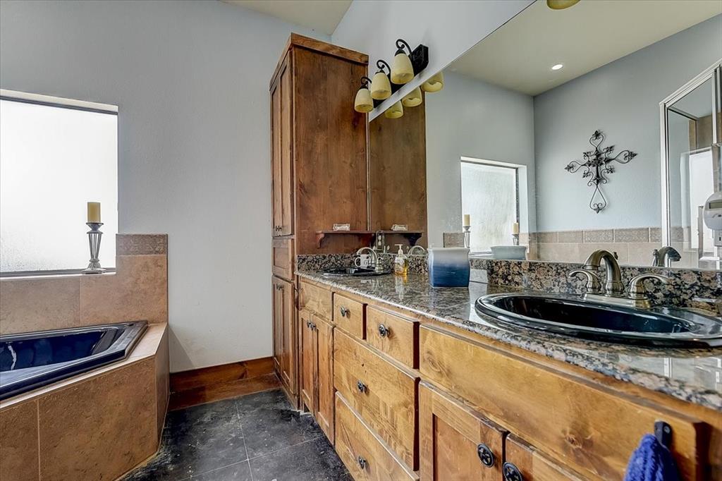 9494 Waide Road Sanger, TX 76266 - Photo 15 of 40 a bathroom with sink a mirror and vanity