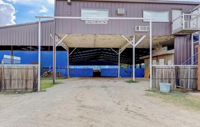 a view of a house with wooden fence