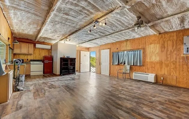 a view of a livingroom with furniture staircase and windows