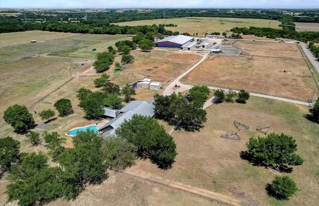 an aerial view of a house with a lake view