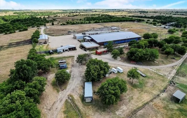 an aerial view of a house with garden space and lake view