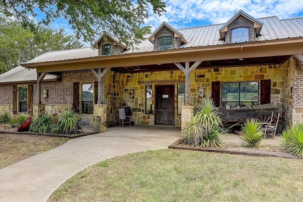 9494 Waide Road Sanger, TX 76266 - Photo 7 of 40 a front view of a house with garden